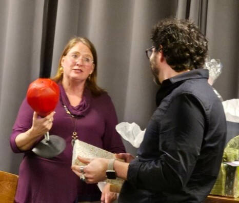 Mary Bower-Russa passing off baton to Chris Kurby
